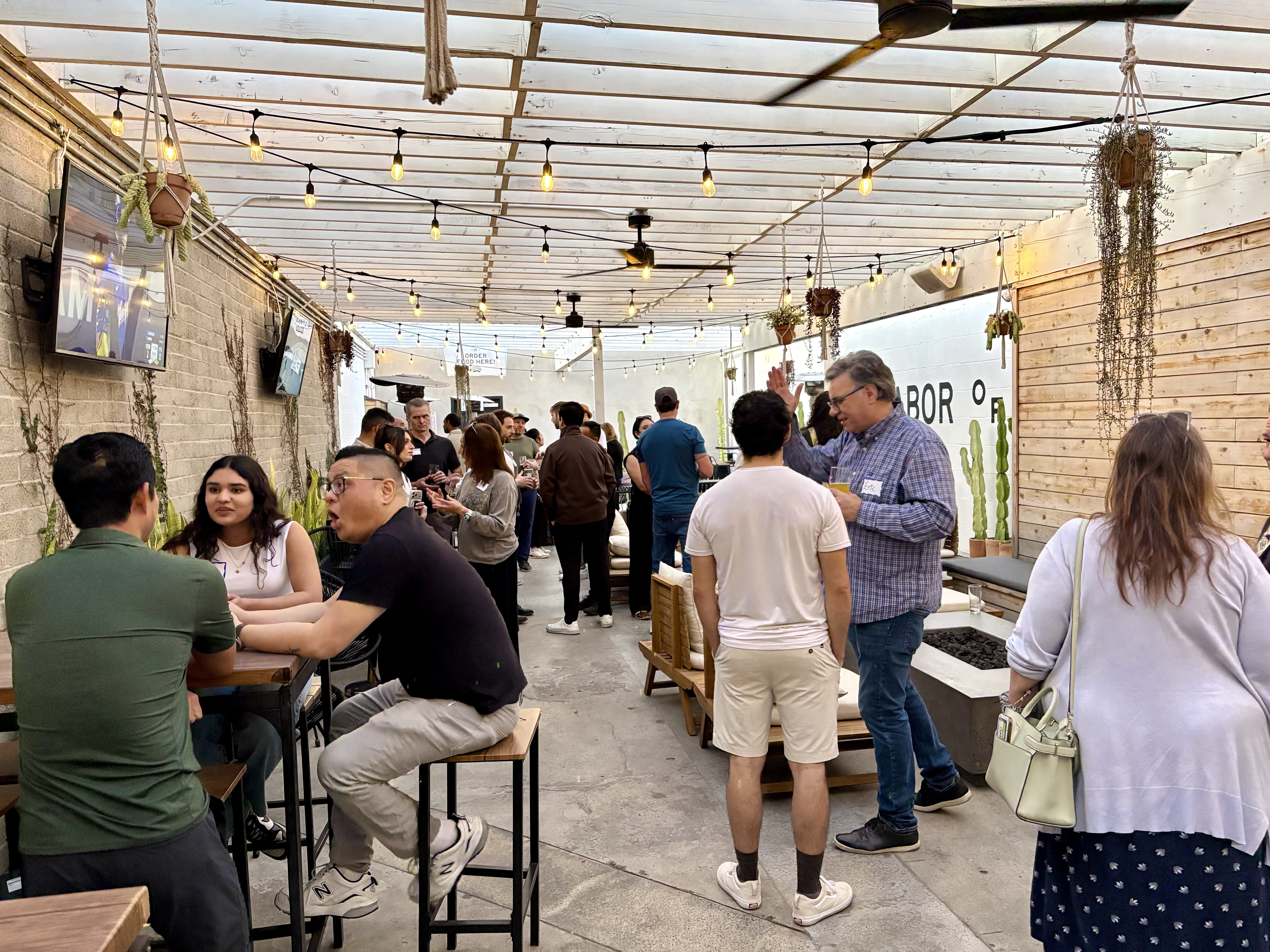 Community gathering with string lights at a San Diego venue